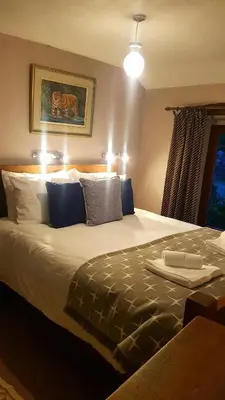 a bedroom with a large bed with blue pillows at The Big 