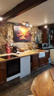 a kitchen with a counter with a stove top oven at The Big 