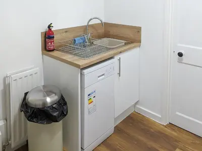 a small kitchen with a sink and a dishwasher at Squirrels Retreat - Uk30821 in Braithwaite