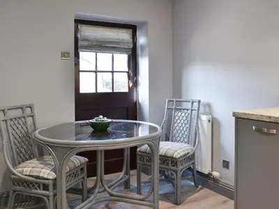 a dining room table and chairs with a bowl on it at The Milking Parlour - Uk30866 in St Bees
