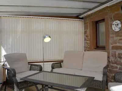 a living room with two chairs and a table at The Milking Parlour - Uk30866 in St Bees