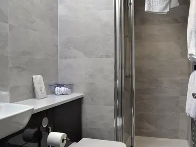 a bathroom with a shower and a toilet and a sink at The Milking Parlour - Uk30866 in St Bees