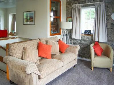 a living room with a couch and a chair at The Coach House - Uk30813 in Braithwaite