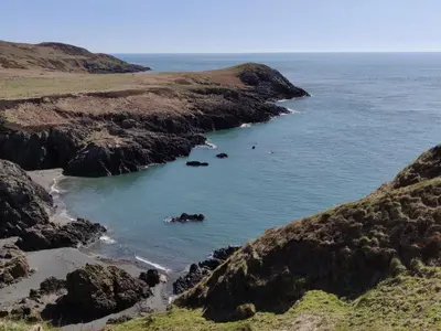 a view of a beach with rocks in the water at Wild Geese Lodge - Uk31046 in Portpatrick