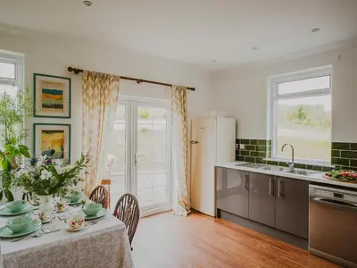 a kitchen with a table with a table cloth on it at Wild Geese Lodge - Uk31046 in Portpatrick