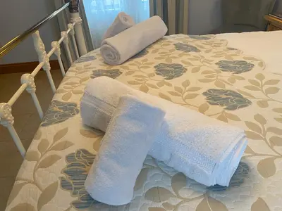 a bed with towels on top of it at Lakeland Snug in Keswick