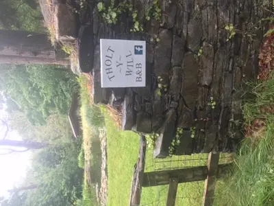 a sign that is on the side of a building at Tholt-y-Will B&B in Sulby