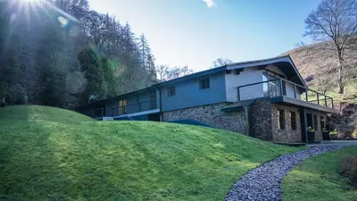 a house on top of a grassy hill at Tholt-y-Will B&B in Sulby