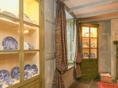 a dining room with blue and white plates and a door at The Precinct House in Newton Stewart