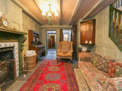 a living room with a couch and a fireplace at The Precinct House in Newton Stewart