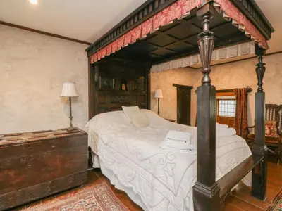 a bedroom with a canopy bed in a room at The Pend in Newton Stewart