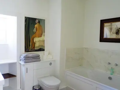 a bathroom with a toilet and a painting on the wall at The Royal Apartment - Uk31086 in Portpatrick