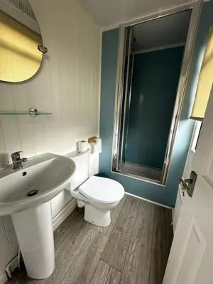 a bathroom with a white toilet and a sink at Bunnahabhain 5 - Farm Stay - Stunning sea and rural views in Stranraer