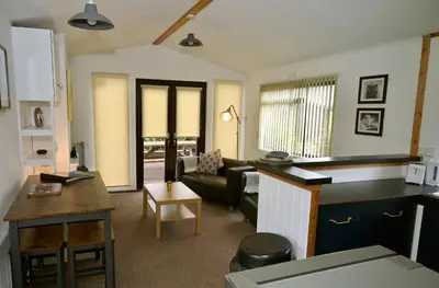 a kitchen and living room with a couch and a table at Ardbeg 4 - Farm Stay with Sea Views across to Northern Ireland in Stranraer