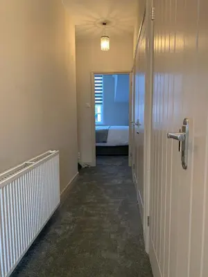 an empty hallway with a room with a bed in it at 5a Bank Street in Keswick