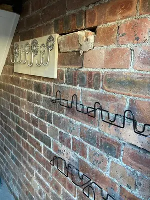 a brick wall with a sign on it at 5a Bank Street in Keswick