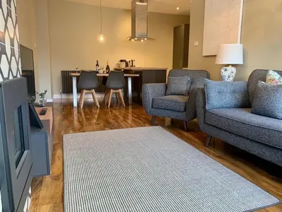 a living room with a couch and chairs and a table at 5a Bank Street in Keswick