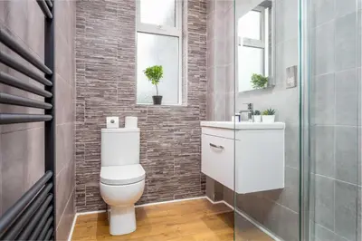 a bathroom with a toilet and a sink at Seafield House - Donnini Apartments in Ayr