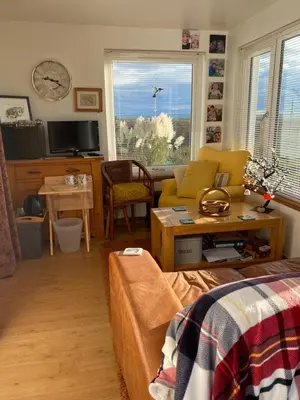 a living room with a couch and a table at Jacquie's B&B -Dumfries-Room with a view in Dumfries