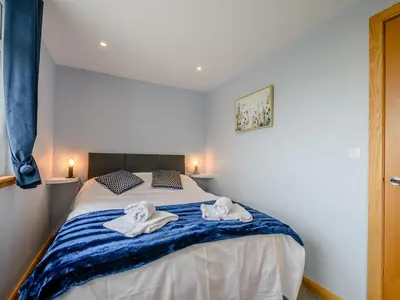 a bedroom with a bed with towels on it at Sand View in Mainsriddle