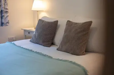 a bed with two pillows on top of it at Walker Suite No82 - Donnini Apartments in Kilmarnock