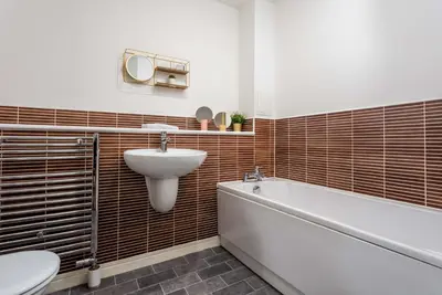 a bathroom with a sink and a tub and a toilet at Walker Suite No82 - Donnini Apartments in Kilmarnock