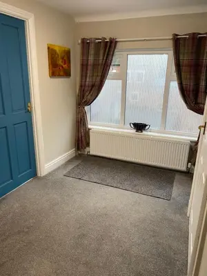 a room with a window and a radiator and a blue door at Kezbah2 22 the square centre of Dalston village in Dalston