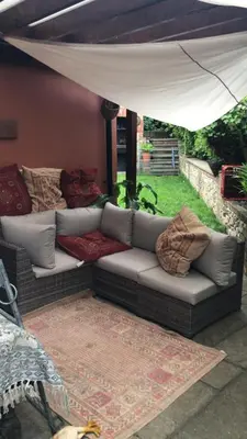 a couch sitting under a tent in a yard at Reayrt Ny Marrey in Kirkmichael