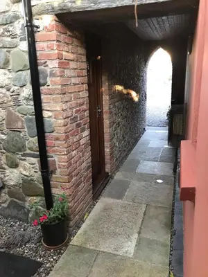 an entrance to a brick building with a door at Reayrt Ny Marrey in Kirkmichael