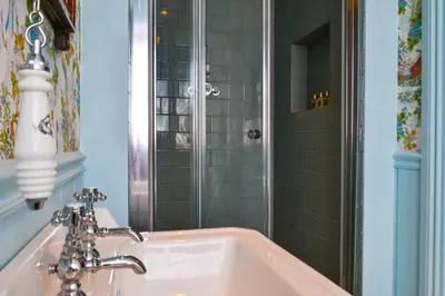 a bathroom with a sink and a shower at The Munches Room at Buittle Castle in Castle Douglas