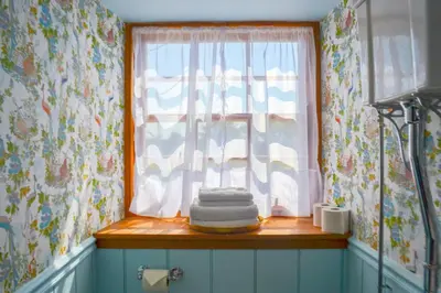 a window with a pile of towels on a window sill at The Munches Room at Buittle Castle in Castle Douglas