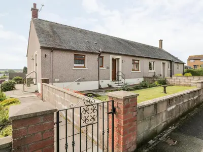 a house with a fence in front of it at Tarnacrye in Annan