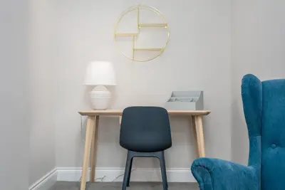 a desk with a chair and a mirror at Seaforth Suite - Donnini Apartments in Ayr