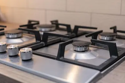 a row of burners on a stove in a kitchen at Seaforth Suite - Donnini Apartments in Ayr