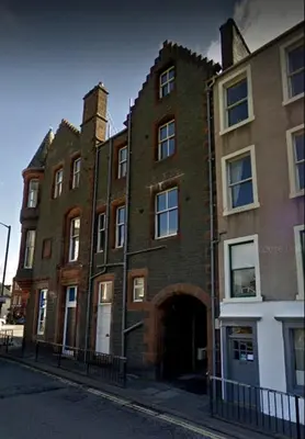 a large brick building on the side of a street at Kirkview House in Moffat
