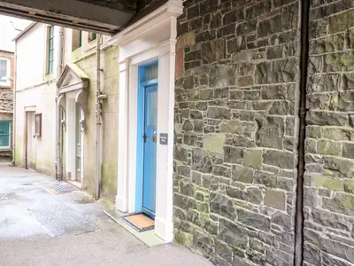 a blue door on the side of a brick building at Kirkview House in Moffat
