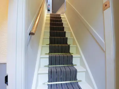 a stairway with a carpet and a stair case at The Coach House in Newton Stewart