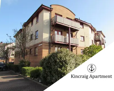 an apartment building with a balcony on a street at Kincraig Apartment in Ayr
