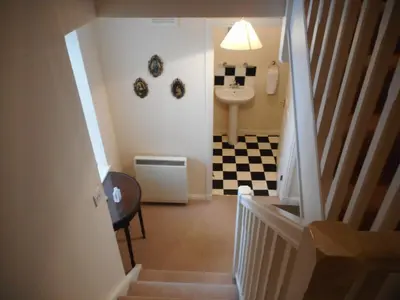 a hallway with a bathroom with a sink and a toilet at DairyCottage, 5, TELFORD MEWS BEATTOCK in Moffat