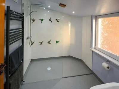 a small bathroom with birds on the wall at Uplands in Dalbeattie