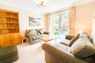 a living room with a couch and a chair at Briarwood House in Keswick