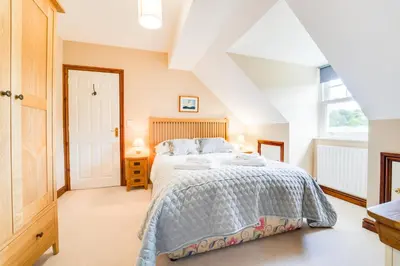 a bedroom with a bed and a window at Briarwood House in Keswick