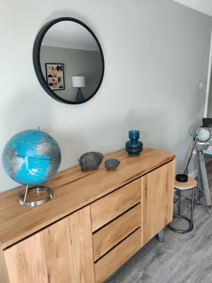a mirror on top of a wooden dresser at Anchors Away in Ayr