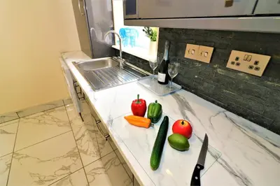 a kitchen counter with apples and vegetables on it at Signature - Kirkhill House in Kirkmuirhill