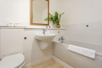 a bathroom with a toilet and a sink and a tub at Walker Suite No53 - Donnini Apartments in Kilmarnock