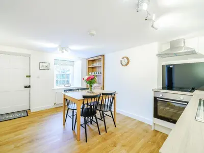 a kitchen with a table and chairs in a room at Branthwaite Cottage in Caldbeck