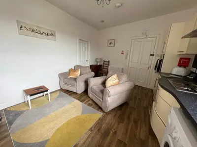 a living room with two chairs and a couch at Stylish 2nd Floor Georgian 1 Bedroom Apartment in Dumfries