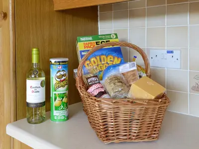 a basket on a counter with food and a bottle of wine at Bel-Mar in Whithorn