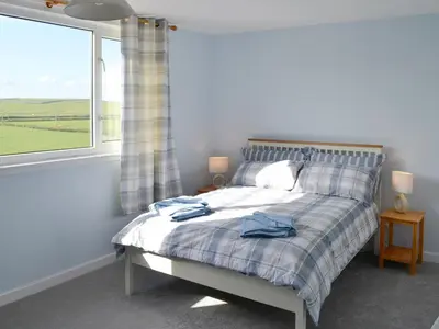 a bedroom with a bed and a window at Bel-Mar in Whithorn