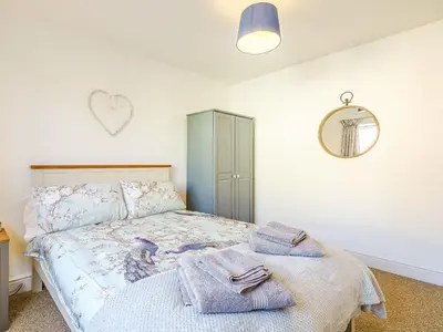 a bedroom with a bed with towels on it at Seacote Gardens in St Bees